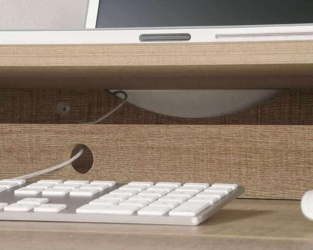 a computer keyboard sitting on top of a wooden desk