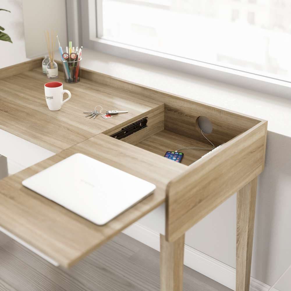 a wooden desk with a laptop and a cup on it