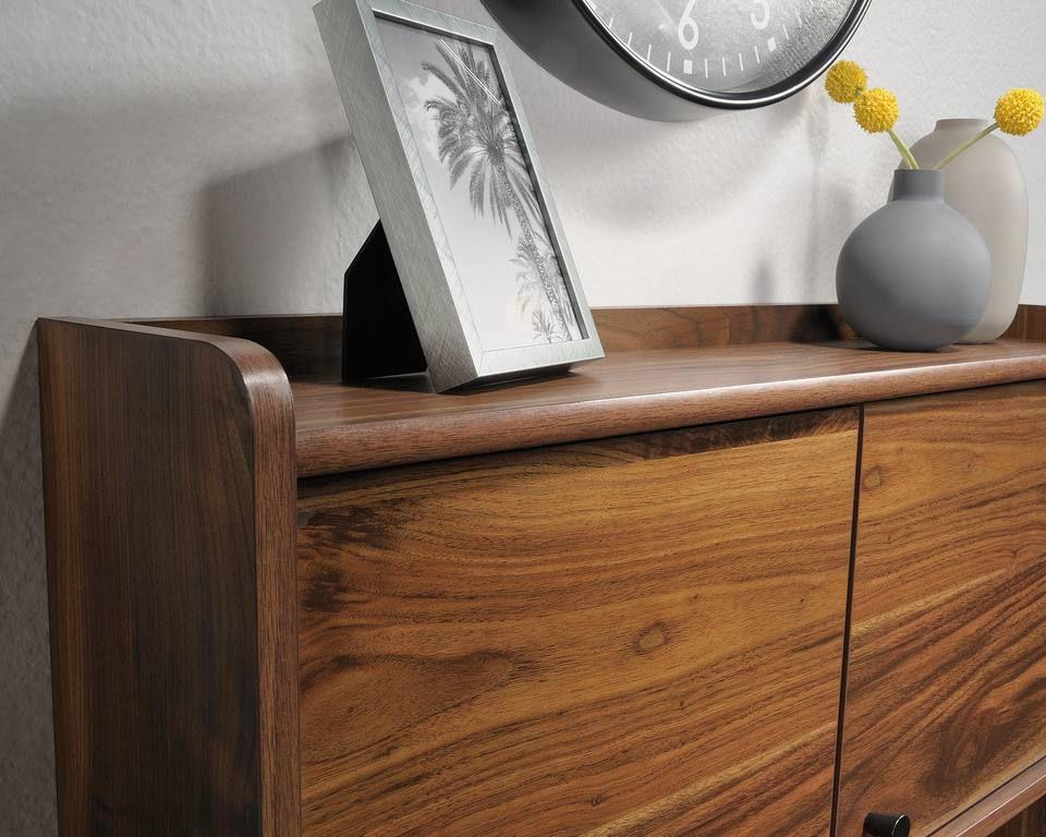 a wooden dresser with a clock on top of it