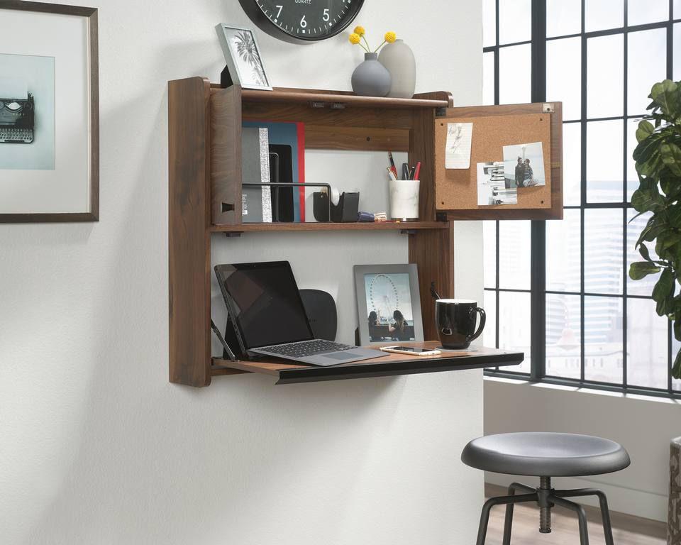 a laptop computer sitting on top of a wooden shelf