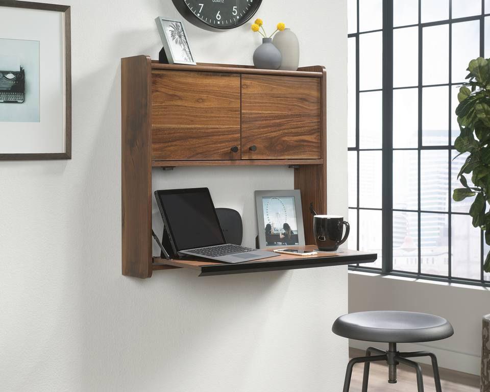 a laptop computer sitting on top of a wooden shelf