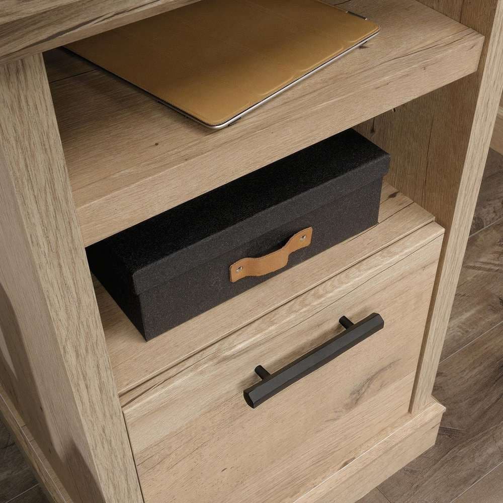 a wooden desk with a laptop and a file cabinet