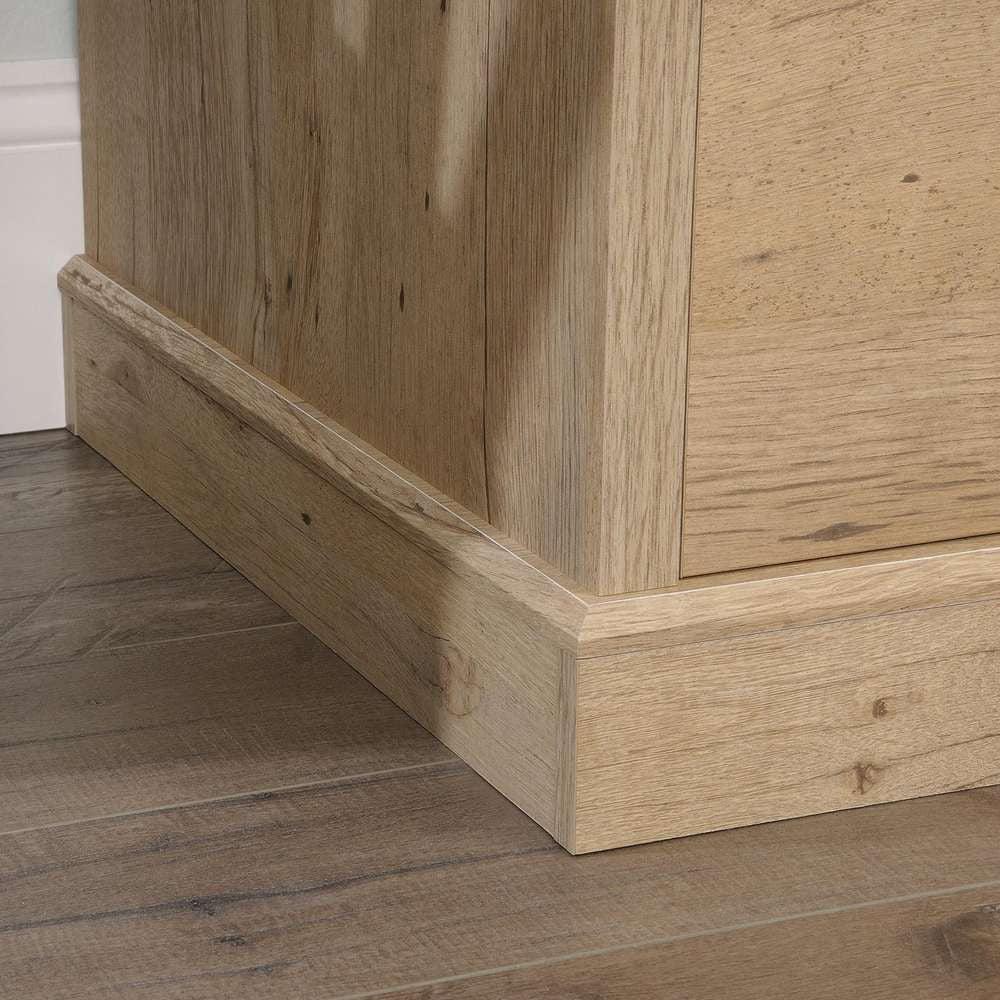 a close up of a wooden floor with a white wall in the background