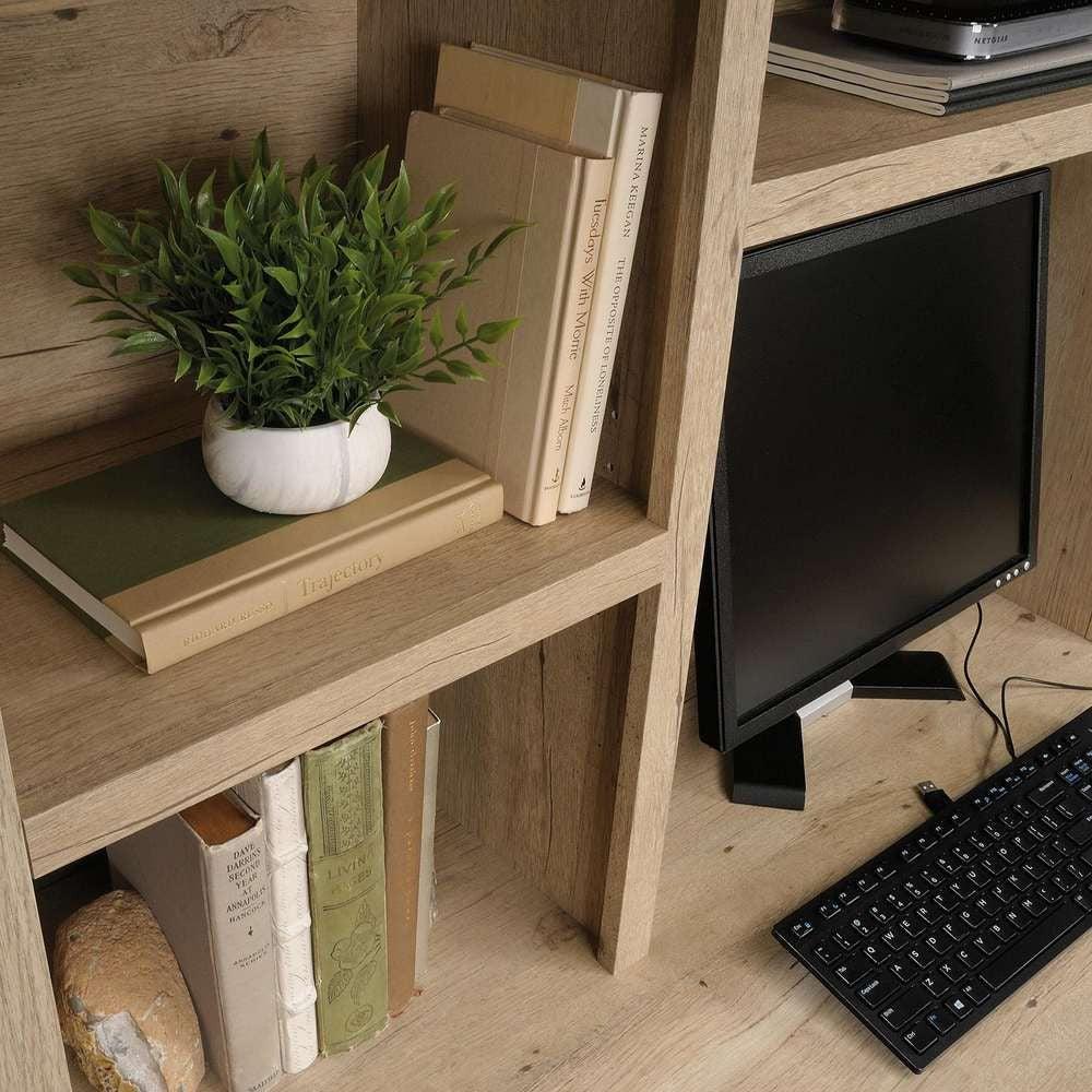 a computer monitor sitting on top of a wooden desk