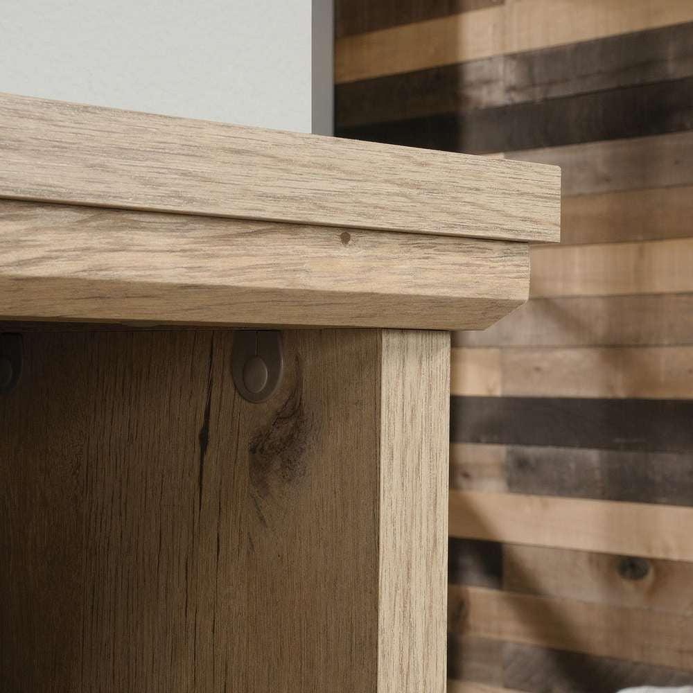 a close up of a wooden shelf with a white wall in the background