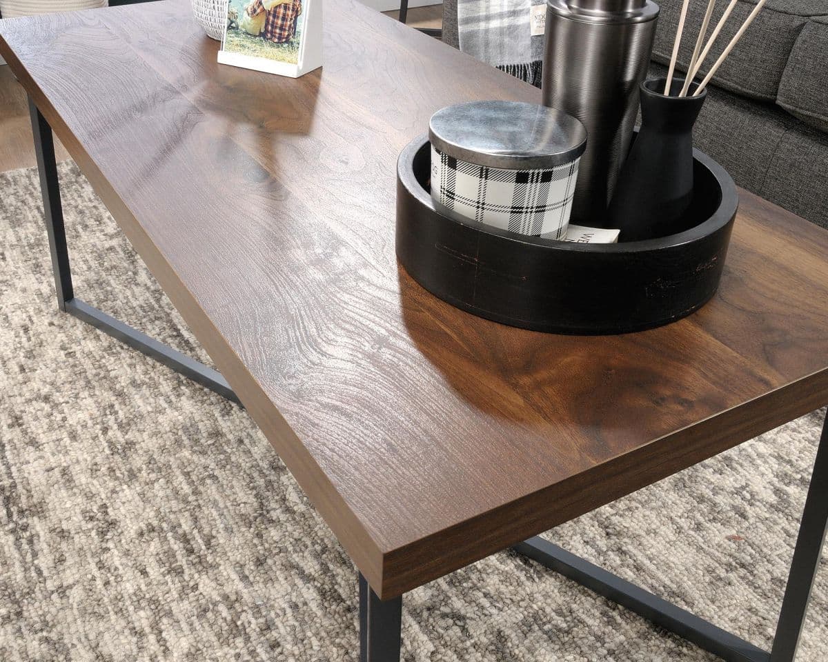 a wooden table with a black metal base