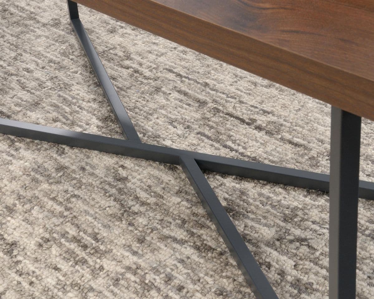 a wooden table sitting on top of a rug