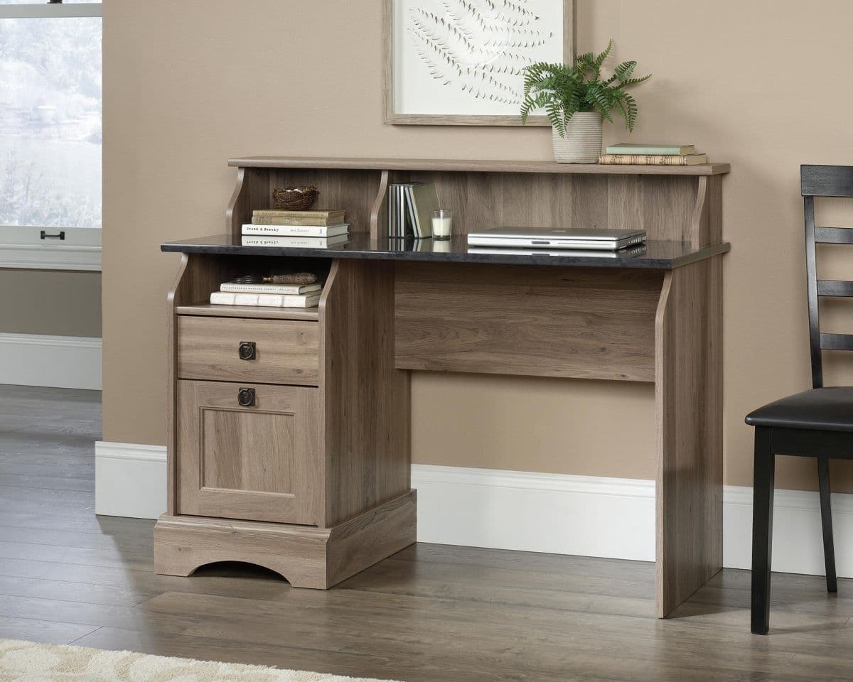 a desk with a book shelf and a chair