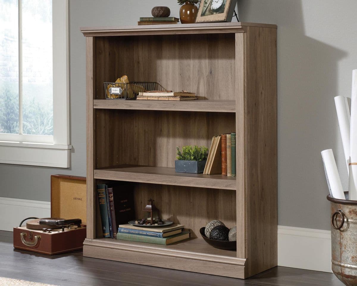 a wooden book shelf with books on top of it