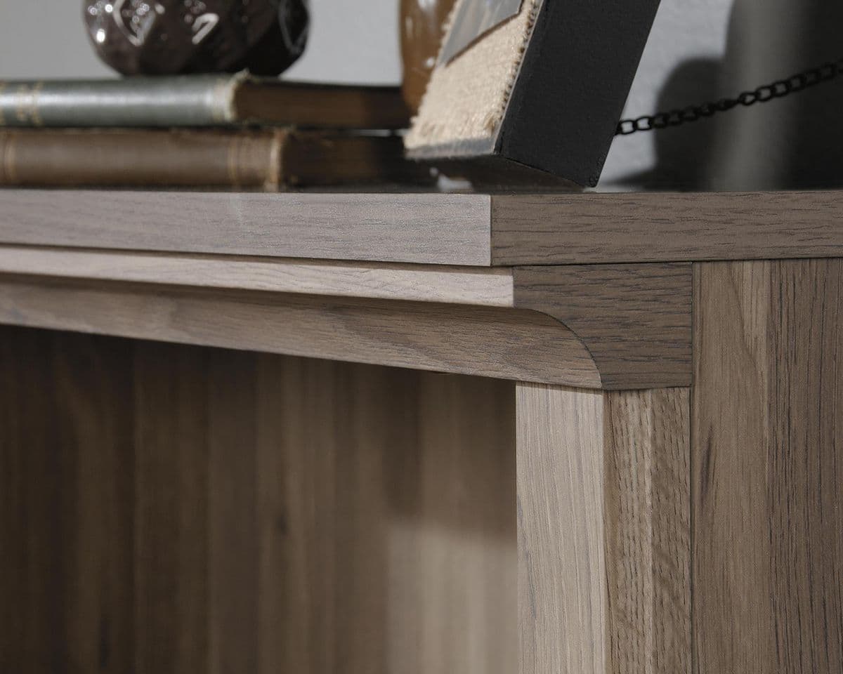 a close up of a book shelf with books on top of it