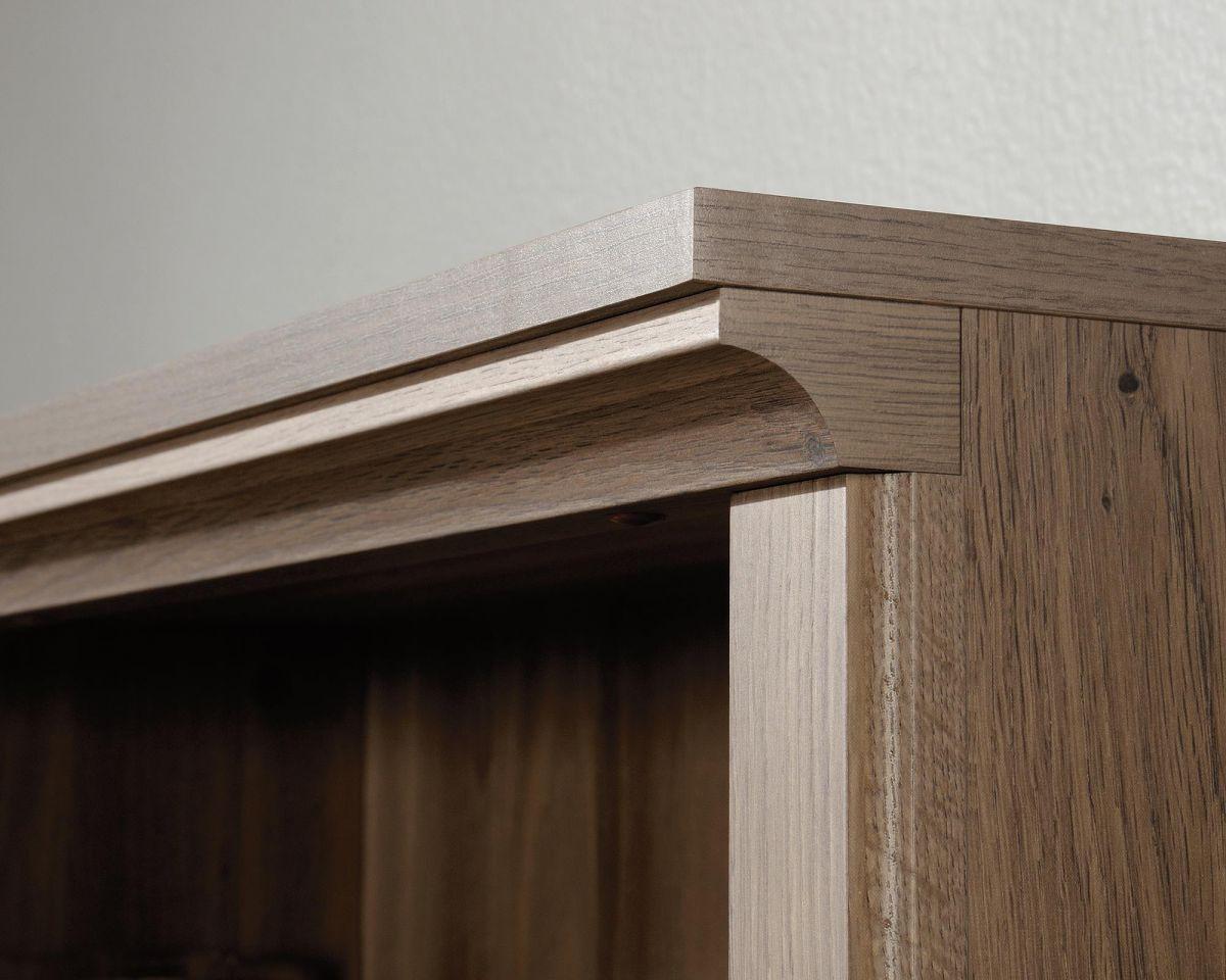 a close up of a wooden shelf with a white wall in the background