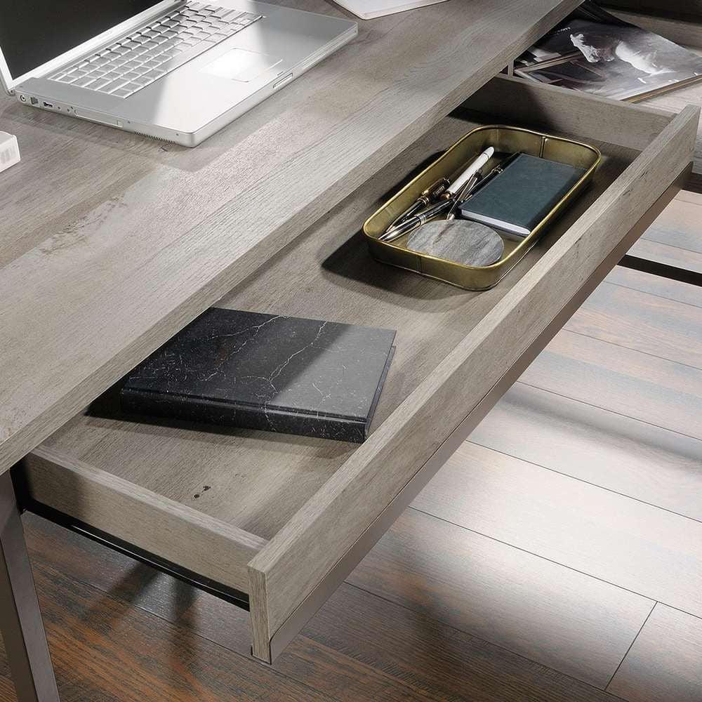 a laptop computer sitting on top of a wooden desk