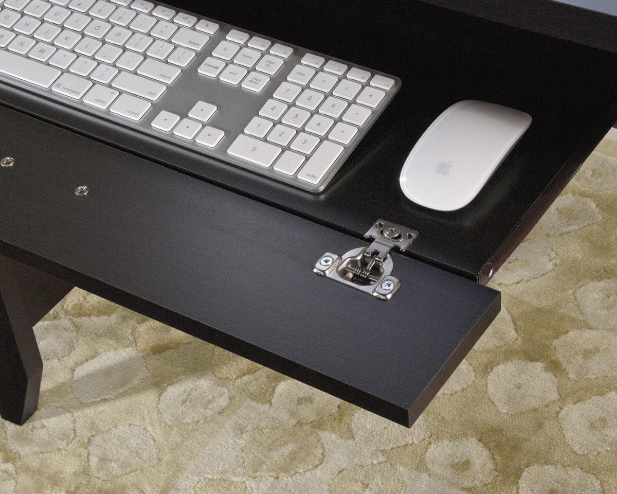 a computer desk with a keyboard and mouse