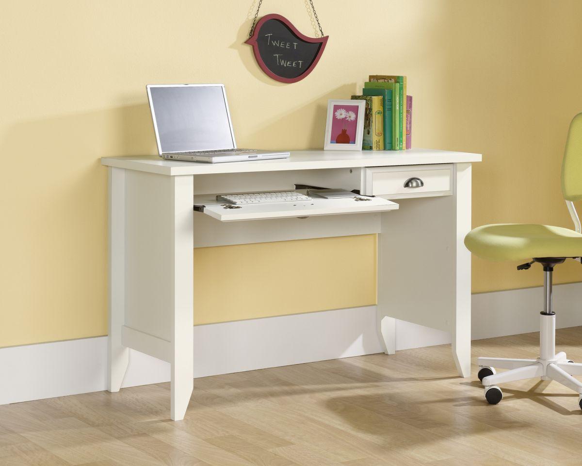 a white desk with a laptop on top of it