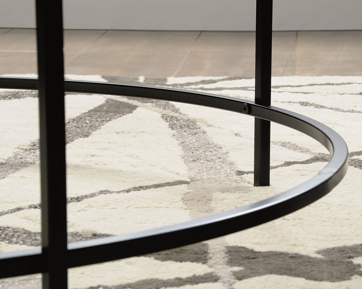 a round metal table with a white rug on the floor