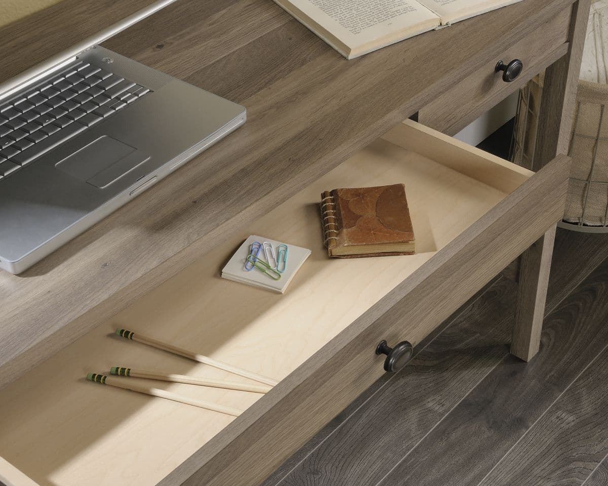 a laptop computer sitting on top of a wooden desk