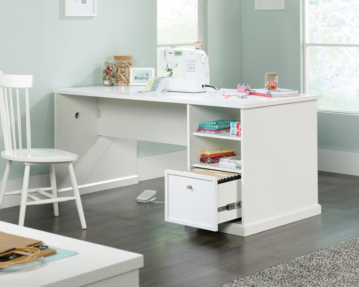 a white desk with a sewing machine on top of it