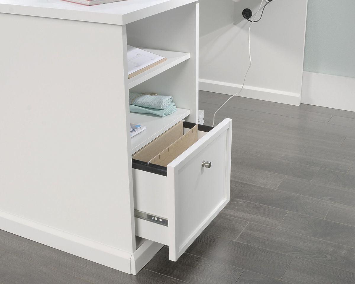 a white desk with a drawer and a phone