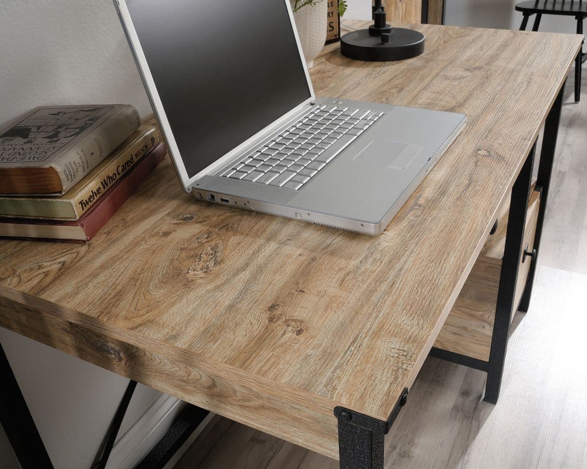 a laptop computer sitting on top of a wooden desk