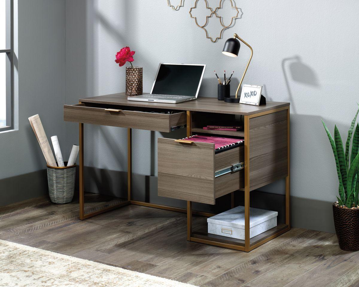 a desk with a laptop and a potted plant