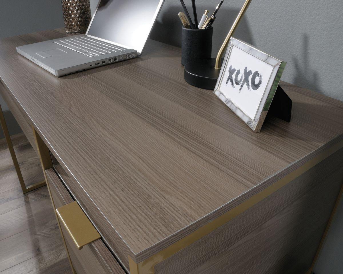 a laptop computer sitting on top of a wooden desk