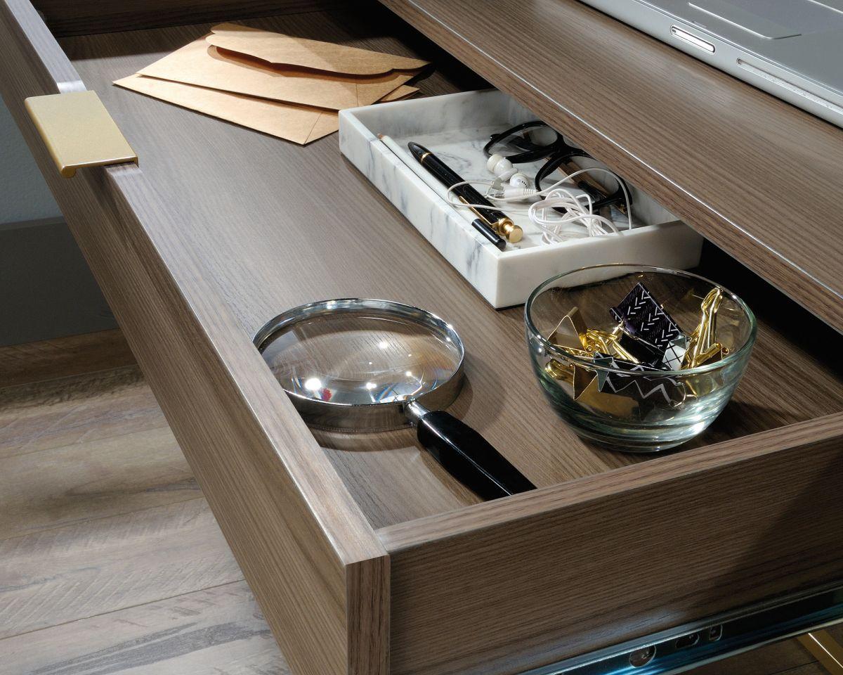 a drawer with a magnifying glass and other items