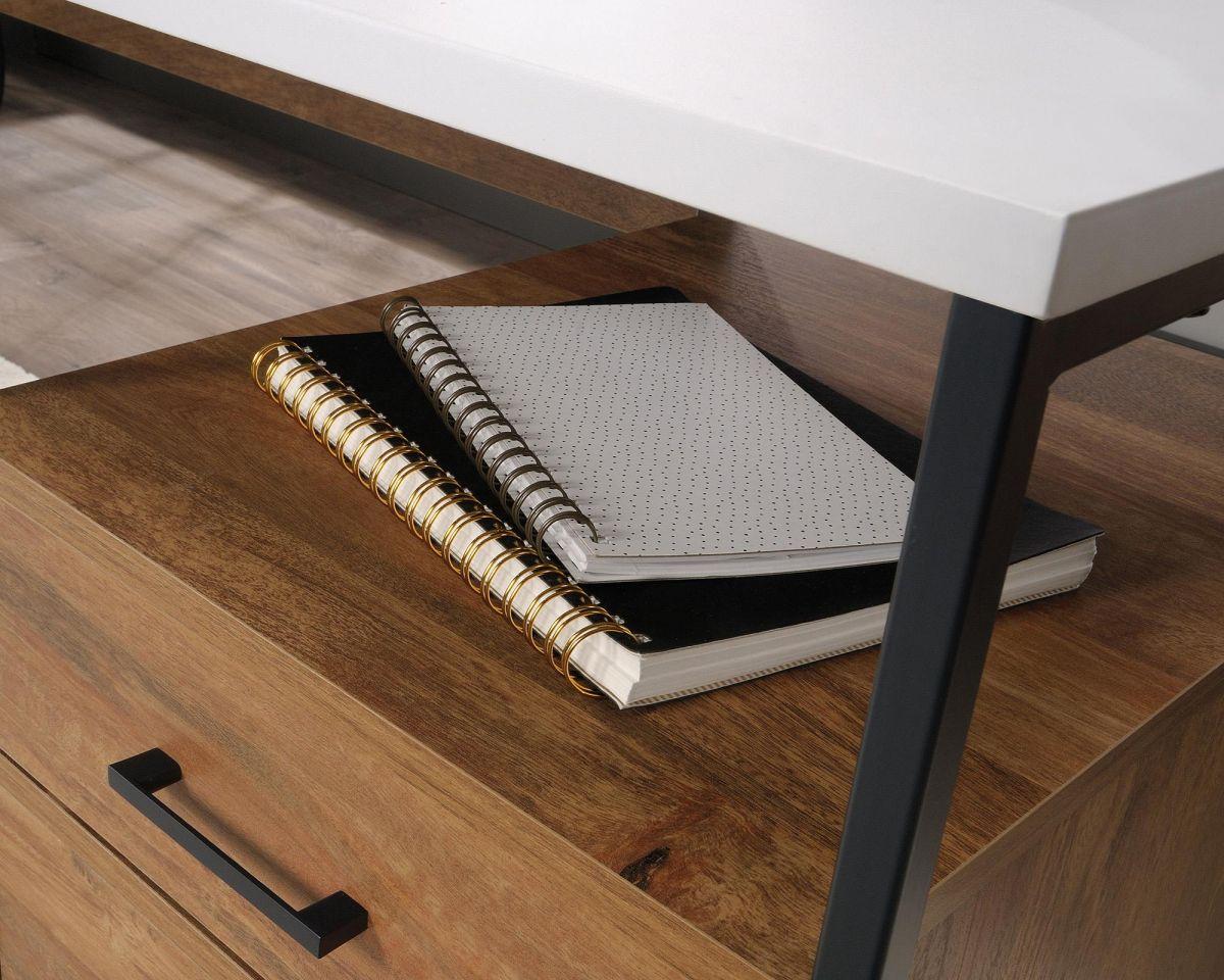 a wooden desk with a notebook on top of it