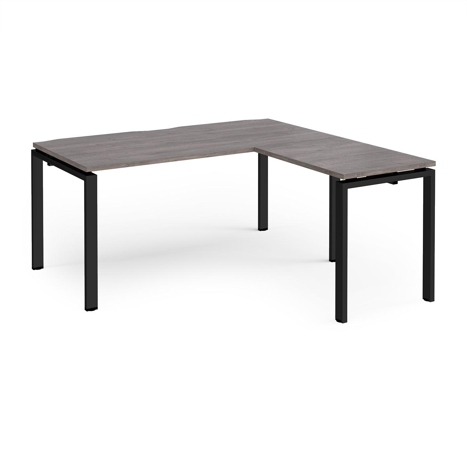 a desk with a black frame and a gray top