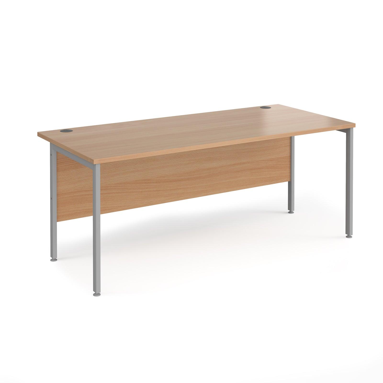 a wooden desk with metal legs on a white background