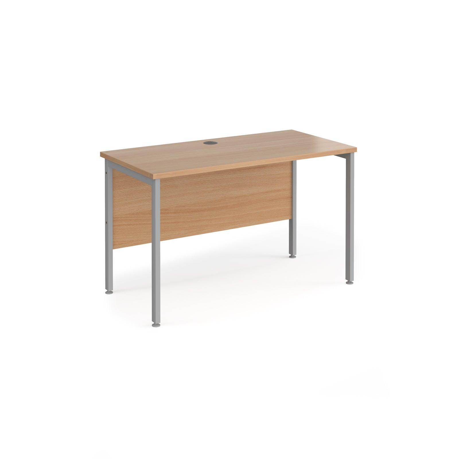 a wooden desk with metal legs on a white background