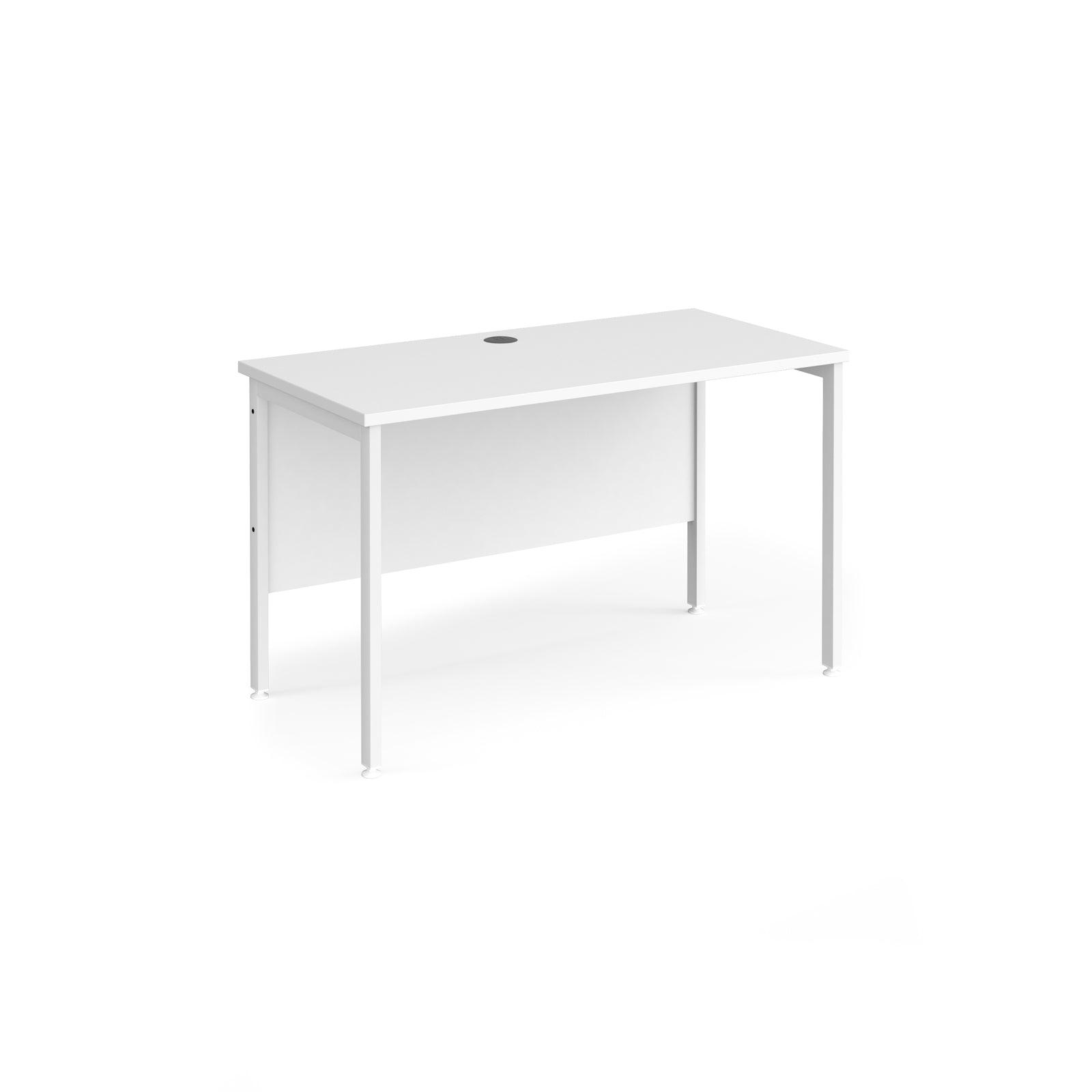 a white desk sitting on top of a white floor