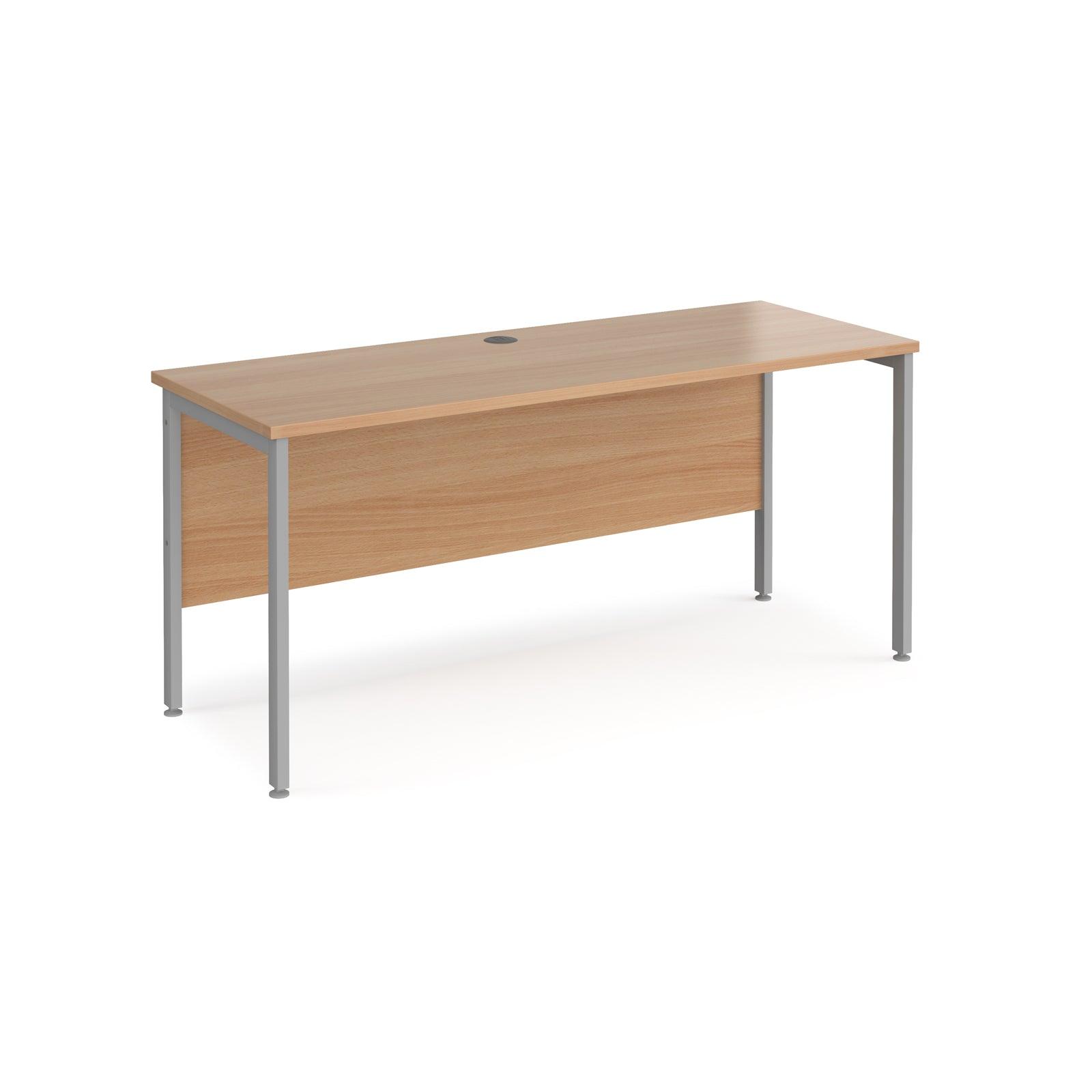 a wooden desk with metal legs on a white background