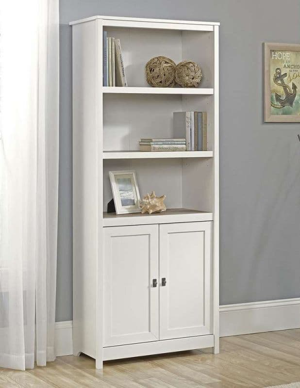 a white bookcase with two doors and a shelf